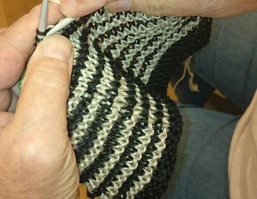 Händer med stickning